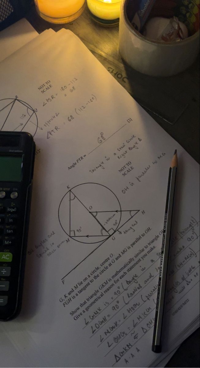 Mathematics work and a calculator on a study desk